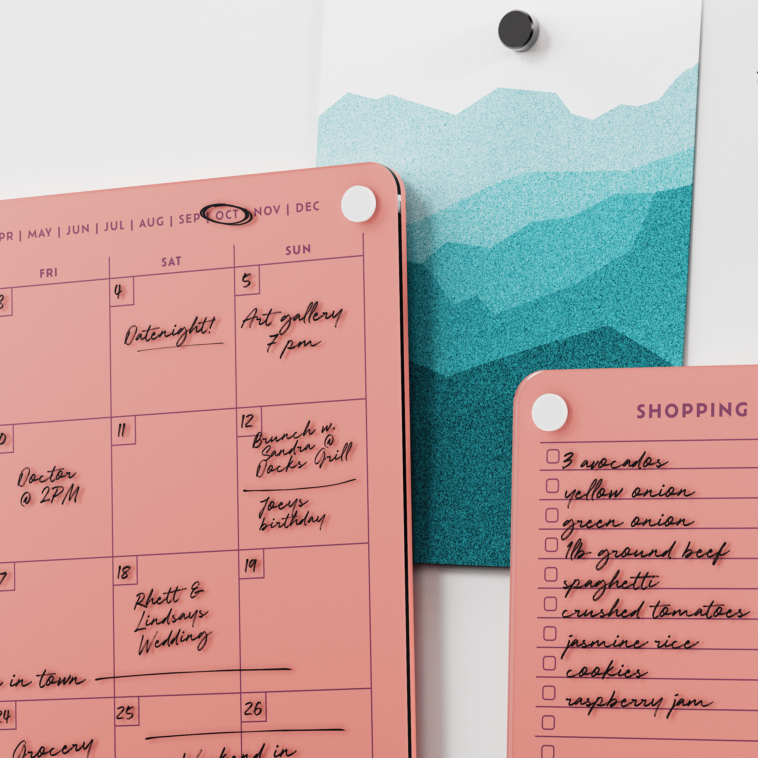 Close-up of the Coral monthly calendar and shopping list boards with handwritten plans and groceries